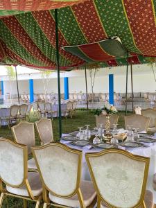 a table set up for a wedding under an umbrella at منتزه السلامة Parc ASSALAMA in Kenitra