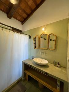 a bathroom with a sink and two mirrors on the wall at La Buyi, Casa de Campo mirando al Champaqui in San Javier +16 photos