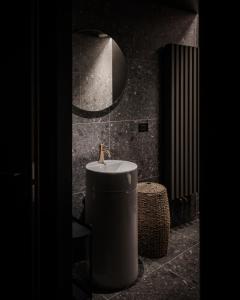 a bathroom with a sink and a mirror at Bach Boutique Hotel in Sappada