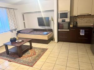 a room with a bed and a table in a kitchen at Mieszkanie dwuosobowe in Tarnów +7 photos