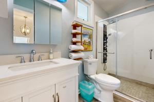 a bathroom with a white toilet and a sink at Sunset Sanctuary in Marathon +17 photos