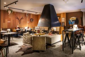 a restaurant with tables and chairs in a room at Bach Boutique Hotel in Sappada