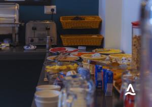 a counter in a kitchen with food on it at Almasur Express Punta Arenas in Punta Arenas