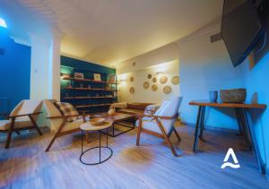 a living room with chairs and a table and a couch at Almasur Express Punta Arenas in Punta Arenas