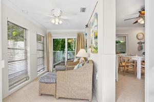 a woman sitting in a chair in a living room at Anna Cabana Bungalow #1 in Holmes Beach