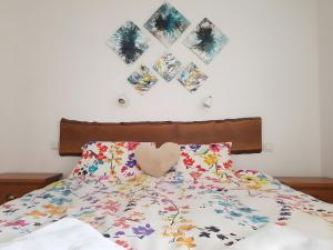 a bed with a heart pillow and pictures on the wall at Lis Martagon in Font-Romeu