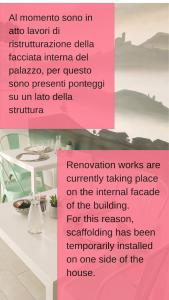 a pink sign in front of a table with a table at B&B Le Albarelle in Alba