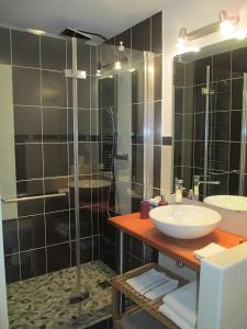 a bathroom with a sink and a glass shower at La Bergerie De L'aulagner in Saint-Barthélemy-le-Meil