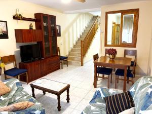 a living room with a couch and a table at Casa De La Virginia in Valdealgorfa