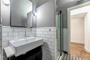 a bathroom with a white sink and a shower at The Heart of Savona A - Cruise 2 min - AC - WiFi in Savona