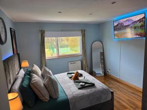 a bedroom with a bed with a dog sitting on it at The Mountain Lake in Fort William