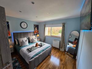 a bedroom with a bed with a dog sitting on it at The Mountain Lake in Fort William