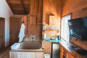 a kitchen with a tub and a tv and wooden walls at The Inn at Manzanita in Manzanita +84 photos