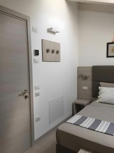 a small bedroom with a bed and a door at Eco Del Garda Bnb in Tenno +30 photos