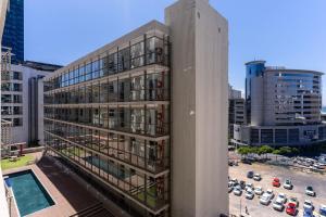a tall building with a pool in a city at 705 Icon Luxury Apartments in Cape Town