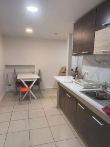 eine Küche mit einem Waschbecken und einem Tisch darin in der Unterkunft Affordable & Cozy Room In Riga Centre - Shared Facilities in Riga + 1 Foto