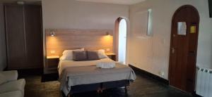 a bedroom with a bed in a room with a window at La Fontana Cabañas in San Carlos de Bariloche