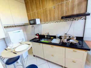 a small kitchen with a sink and a counter at Casa Studio"' São José dos Campos in São José dos Campos