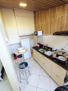 a small kitchen with a sink and a refrigerator at Casa Studio"' São José dos Campos in São José dos Campos +5 photos