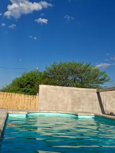 a pool of water next to a wooden fence at Estación La Perla in Alta Gracia