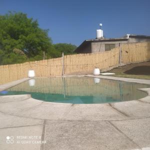 a pool of water in front of a fence at Estación La Perla in Alta Gracia