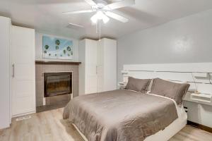 a white bedroom with a bed and a fireplace at Great Outdoor Space! Family Home in SLC Suburbs in Midvale
