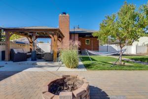 a backyard with a fire pit and a hammock at Great Outdoor Space! Family Home in SLC Suburbs in Midvale