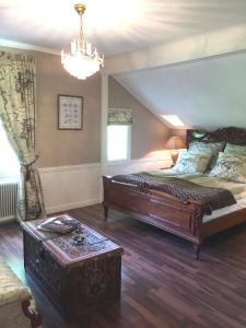 Un dormitorio con una cama grande y una lámpara de araña. en Villa Granvik, en Söderfors