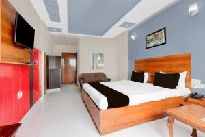 Ένα ή περισσότερα κρεβάτια σε δωμάτιο στο Collection O Taj Empire