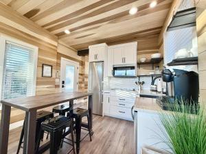 a kitchen with a wooden ceiling and a wooden table at Escalante Escapes Tumble Weed- Bunk Escape in Escalante