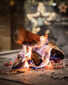 a wooden spatula engulfed in a fire at Bach Boutique Hotel in Sappada