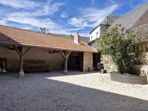 a courtyard of a building with a pavilion with a roof at L'évasion- Appartement cosy in Veuzain-sur-Loire