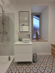 a white bathroom with a sink and a shower at L'évasion- Appartement cosy in Veuzain-sur-Loire +23 photos