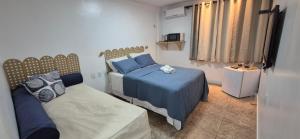 a small bedroom with two beds and a window at MA Prime Stay in Natal