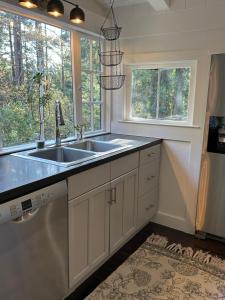 a kitchen with a sink and two windows at Mill Valley Outpost in Mill Valley