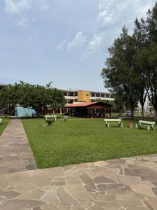 a park with benches in front of a building at Apartamento pé na areia em Tramandaí in Tramandaí