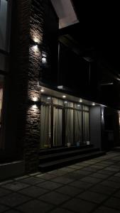 a building at night with lights on the side of it at i7 HOMESTAY in Jāmb