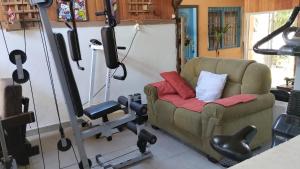 a living room with a couch and gym equipment at Residencial Saldanha in Gramado