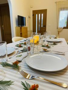 a table with white plates and utensils on it at El Rincón de la Mimosa in Vega de Espinareda +50 photos
