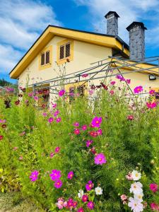 a house with flowers in front of it at El Rincón de la Mimosa in Vega de Espinareda