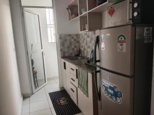 a kitchen with a refrigerator and a sink at Buxton Point Kandy Cozy Two Bedroom Apartment in Mombasa +28 photos