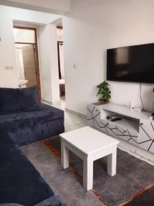 a living room with a couch and a coffee table at Buxton Point Kandy Cozy Two Bedroom Apartment in Mombasa