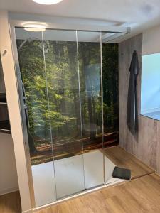 a sliding glass door with a painting on the wall at Dommelhof Fewo in Diemelsee