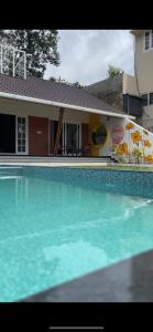 a large swimming pool in front of a building at The VARANDAH LOUNGE 2BHK PRIVATE POOL VILLA VAGAMON in Vagamon