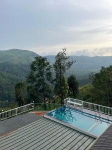 a swimming pool with a view of the mountains at The VARANDAH LOUNGE 2BHK PRIVATE POOL VILLA VAGAMON in Vagamon