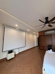 a room with a large projection screen on the wall at JonHouse in Phu Quoc