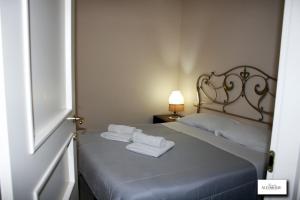 a bedroom with a bed with towels on it at Borgo Antico Santa Lucia in Potenza