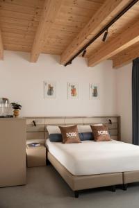 a bedroom with a large bed and wooden ceilings at BOMA Prime Rooms in Civitanova Marche