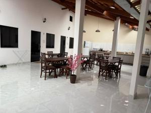 a dining room with wooden tables and chairs at Hospedagens Rebouças in Lençóis