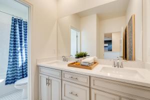 a bathroom with a sink and a mirror at Elegant and Spacious Retreat with Yard in Woodland! in Woodland +29 photos